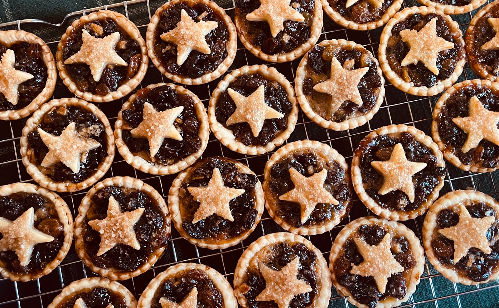 A cooling rack filled with star shaped pastries